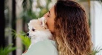 Mujer de espaldas abraza a su perro